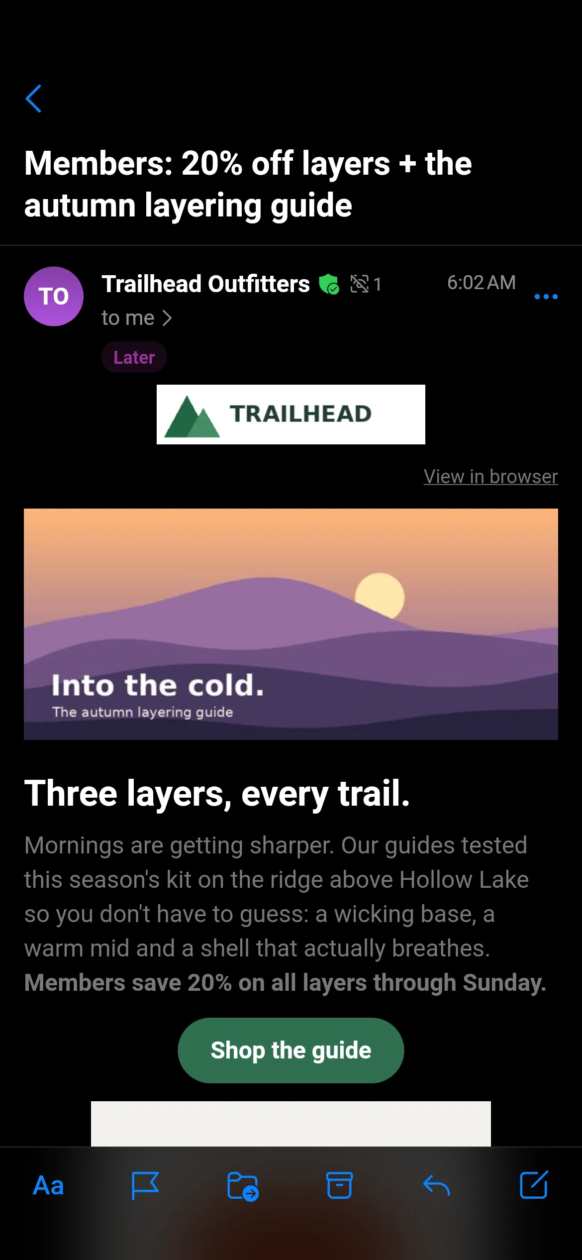 A Trailhead Outfitters newsletter, “Members: 20% off layers + the autumn layering guide”, open in Readable mode: a green verified-sender shield and a tracker count of 1 beside the sender, a purple Later tag, the Trailhead logo, a sunset hero image captioned “Into the cold.”, the heading “Three layers, every trail.”, body text and a green Shop the guide button. The reading toolbar sits at the bottom.